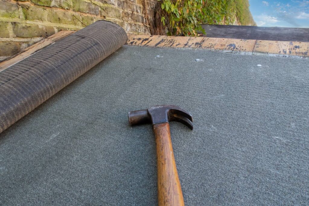 Roofing felt can be hammered into the roof decking, or even stapled in.