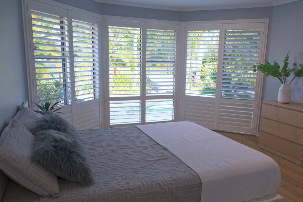 Plantation shutters can cover a whole wall to allow more natural light. 